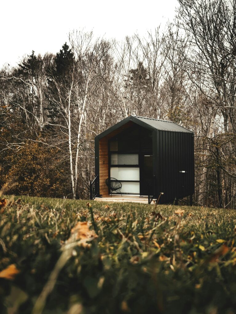 pexels photo 14466293 14466293 A charming wooden cabin nestled in an autumn forest, ideal for a peaceful retreat.